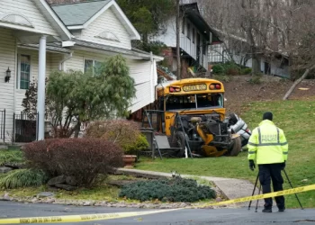 School bus packed with children crashes into house
